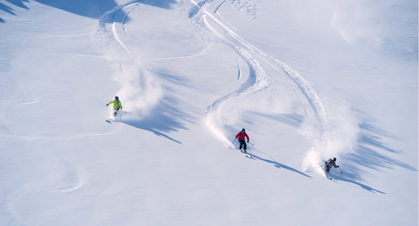 Three people skiing down a slop as website traffic, some of the skiers may be referral traffic.